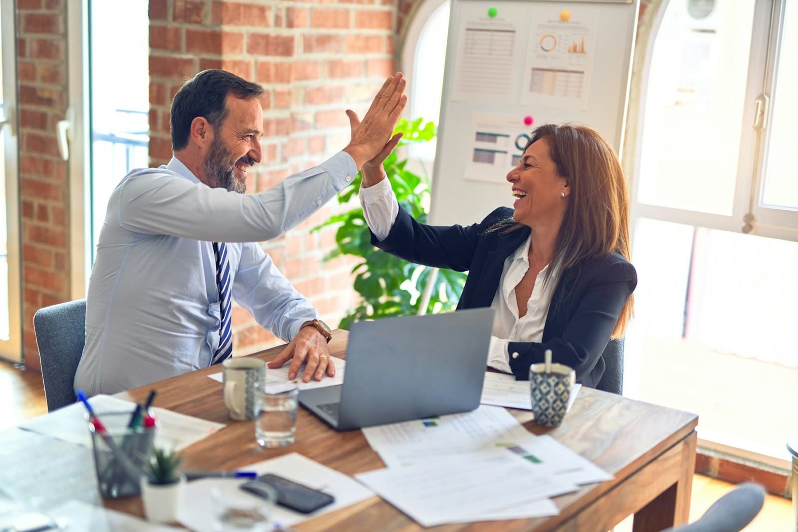 A client and designer celebrating a successful website launch